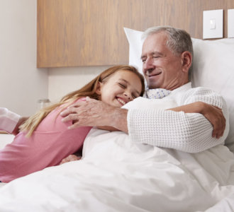 girl hugging elderly man