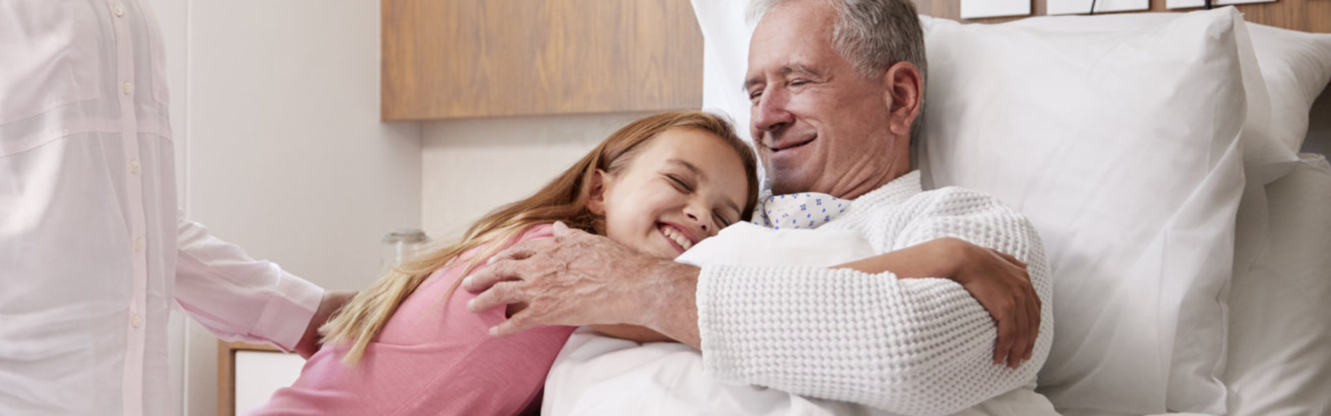 girl hugging elderly man